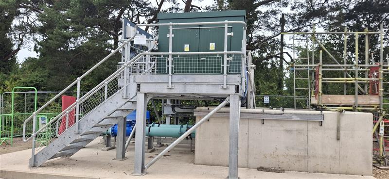 Meta stairs leading to a green pumping station unit