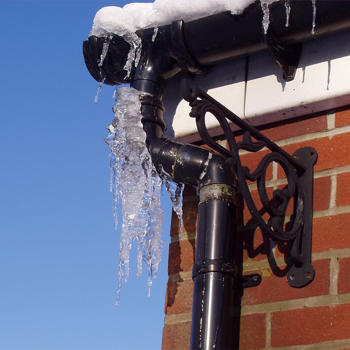 Image of a gutter full of frozen water